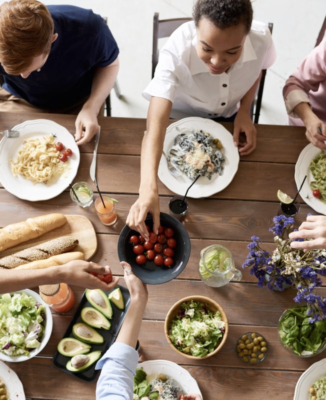 group of people eating a meal at a table